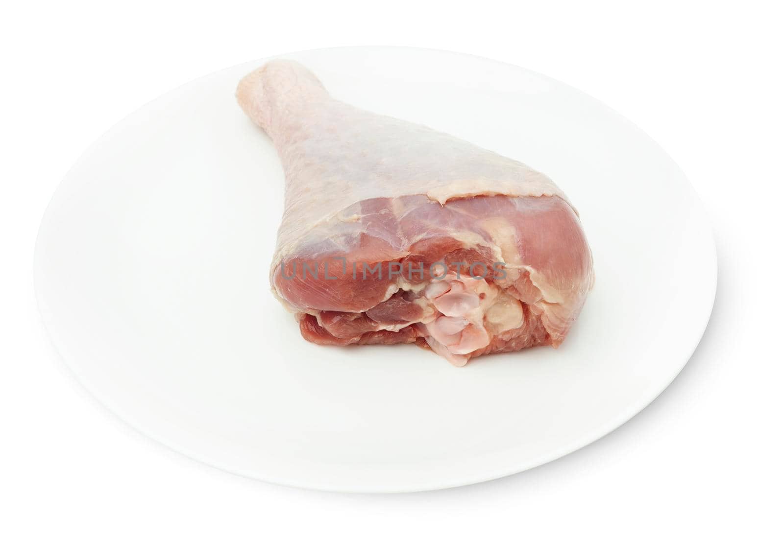 One RAW turkey leg on a white plate isolated on a white bacground. With clipping path