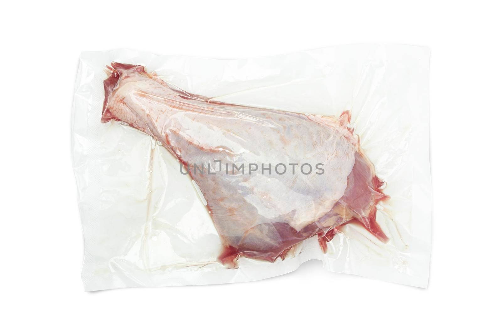 Vacuum packed turkey meat isolated on white background. Raw drumstick. With clippig path