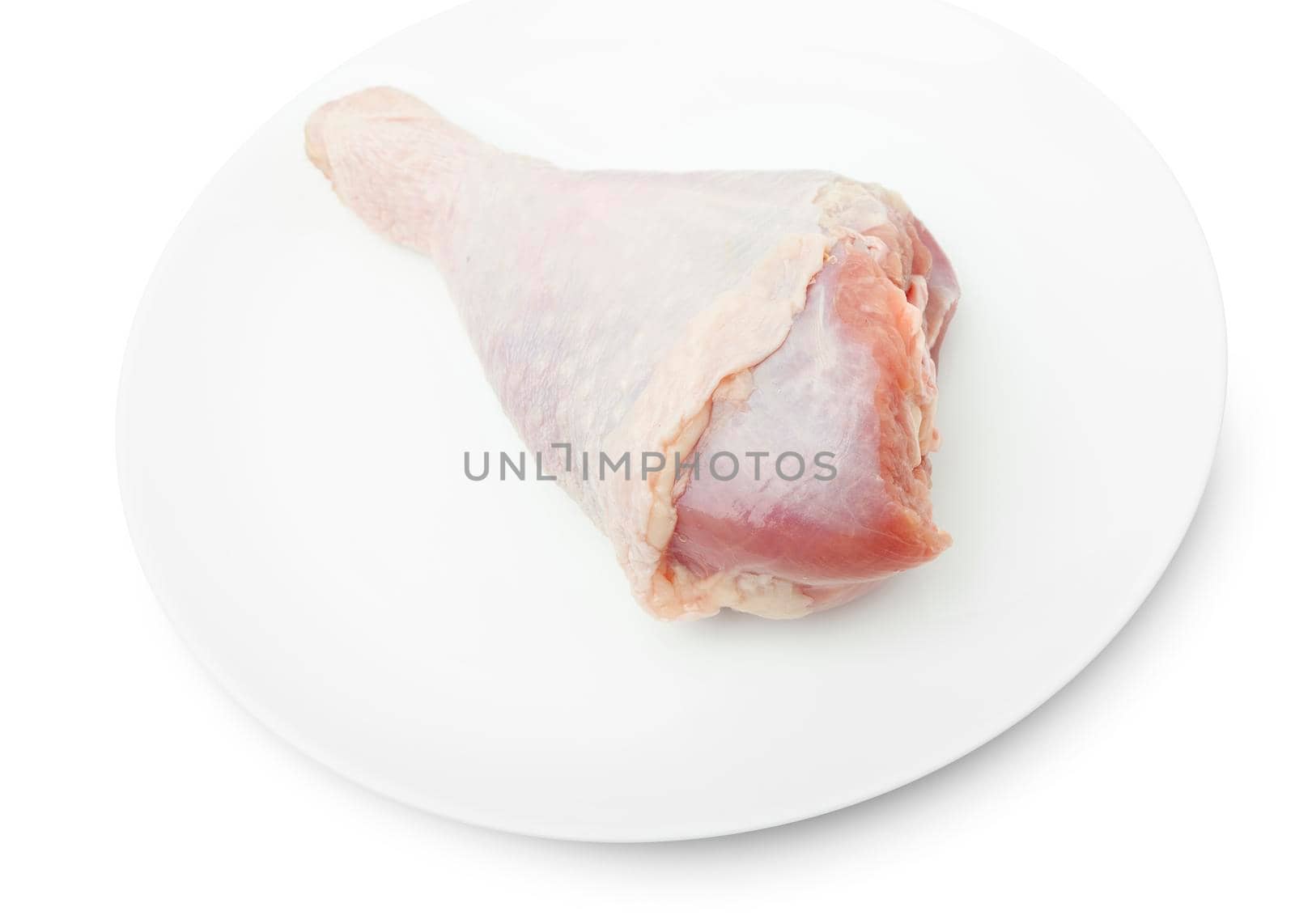 One RAW turkey leg on a white plate isolated on a white bacground. With clipping path