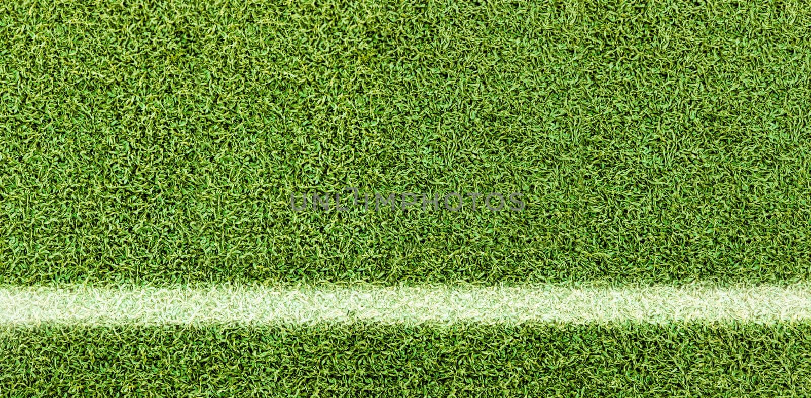 Green grass texture background. Artificial green grass. White Line on the soccer field. Top view of bright grass background. Idea concept used for making green backdrop, lawn for a training football pitch, Grass Golf Courses green lawn pattern textured background.