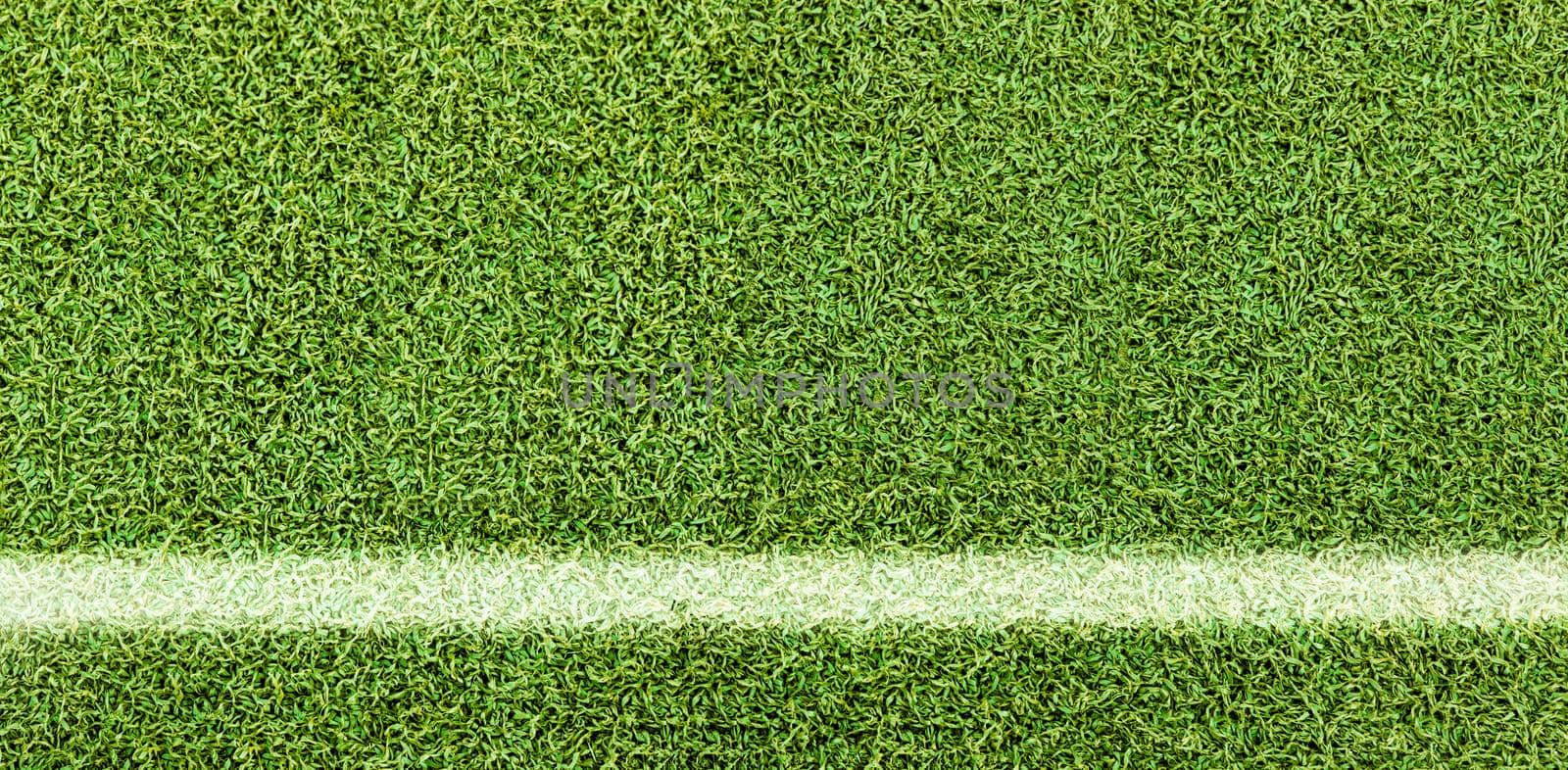 Green grass texture background. Artificial green grass. White Line on the soccer field. Top view of bright grass background. Idea concept used for making green backdrop, lawn for a training football pitch, Grass Golf Courses green lawn pattern textured background.