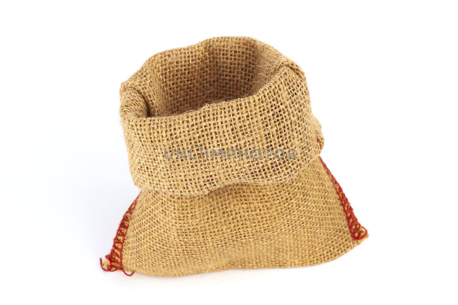 Empty burlap bag or sack to be filled in isolated on white background