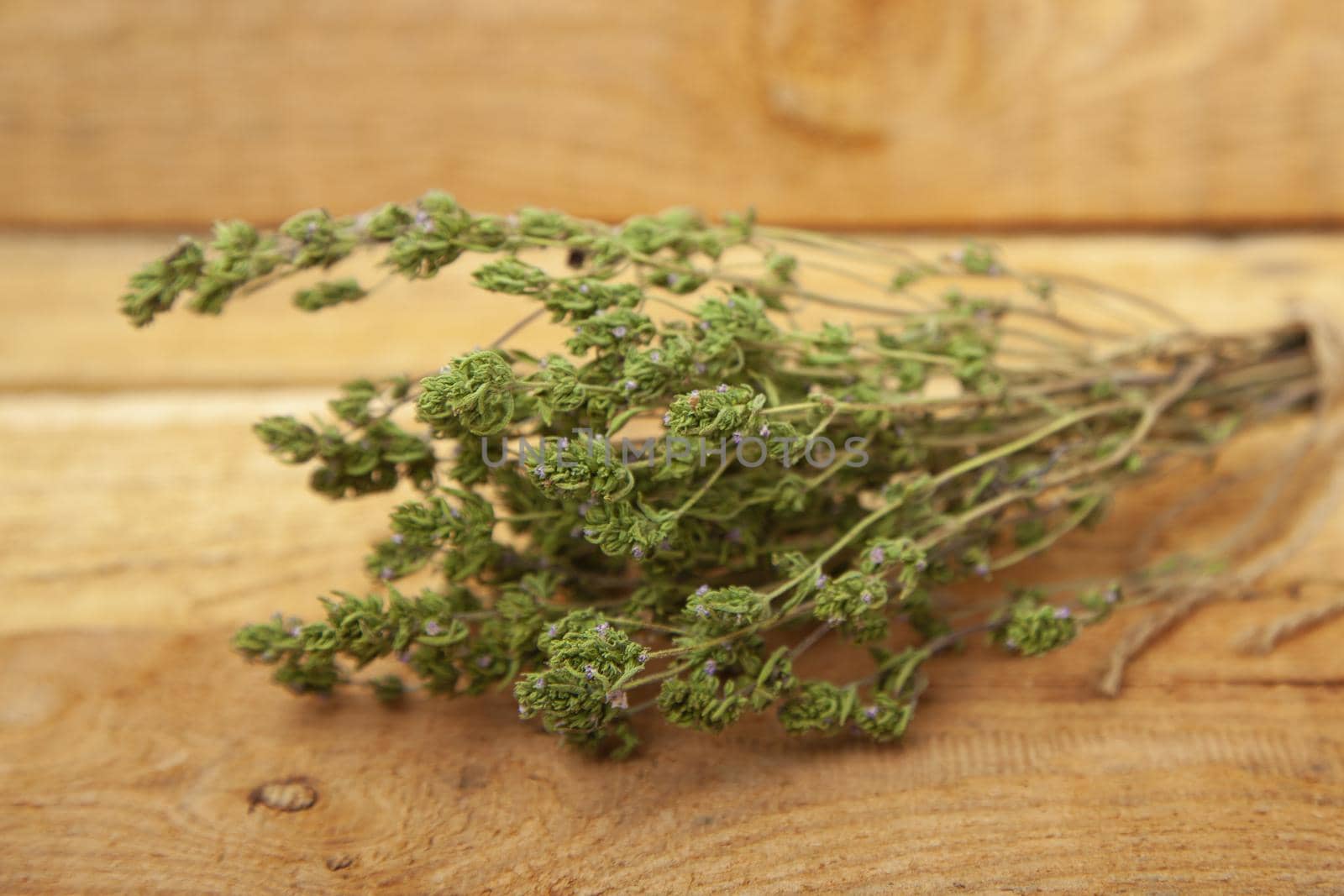 Dry thyme pile on wooden background