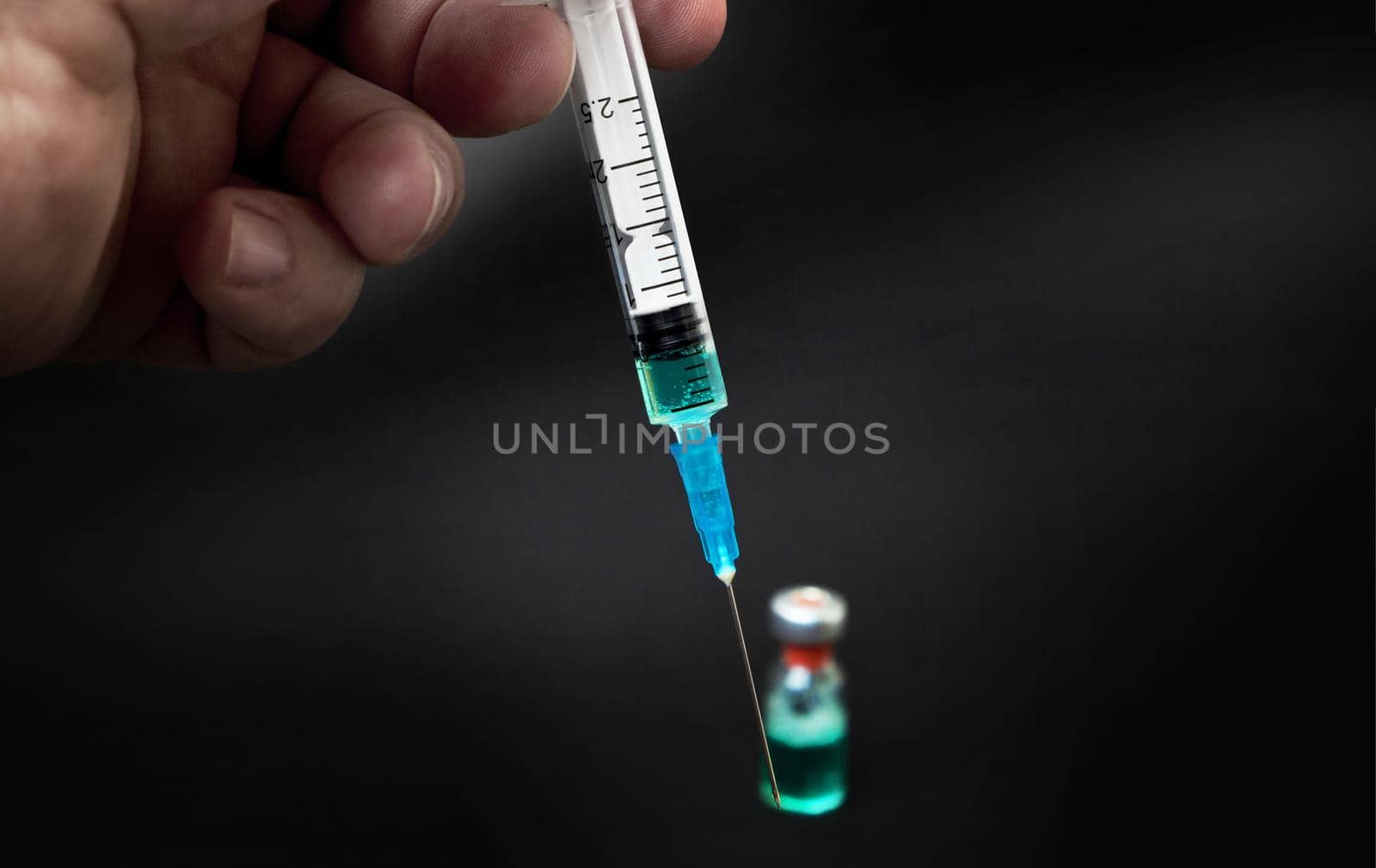 syringe isolated on black background by SlayCer