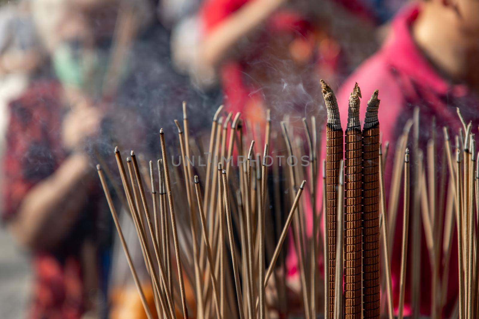 Incense burning with white smoke in an incense pot. by tosirikul