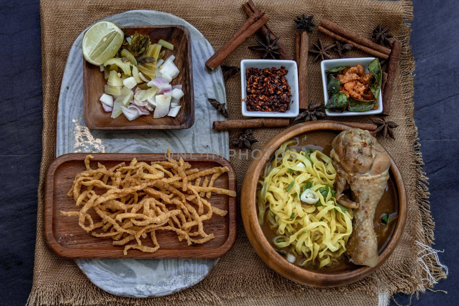 Northern Style Curried Noodle Soup with coconut milk (Khao soi), Traditional of Northern Thai cuisine, Top view.