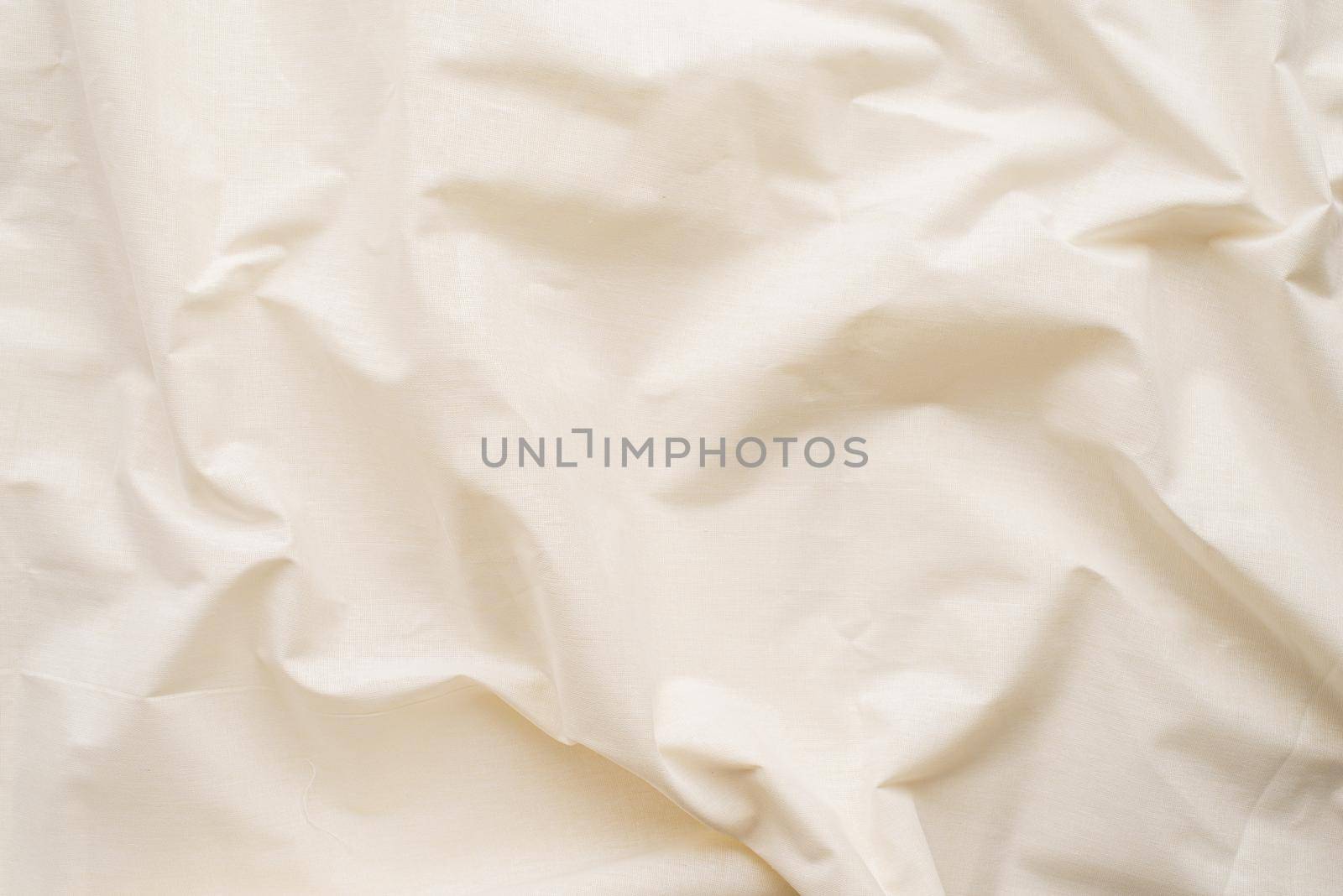 Closeup of rippled white silk fabric. Abstract texture background