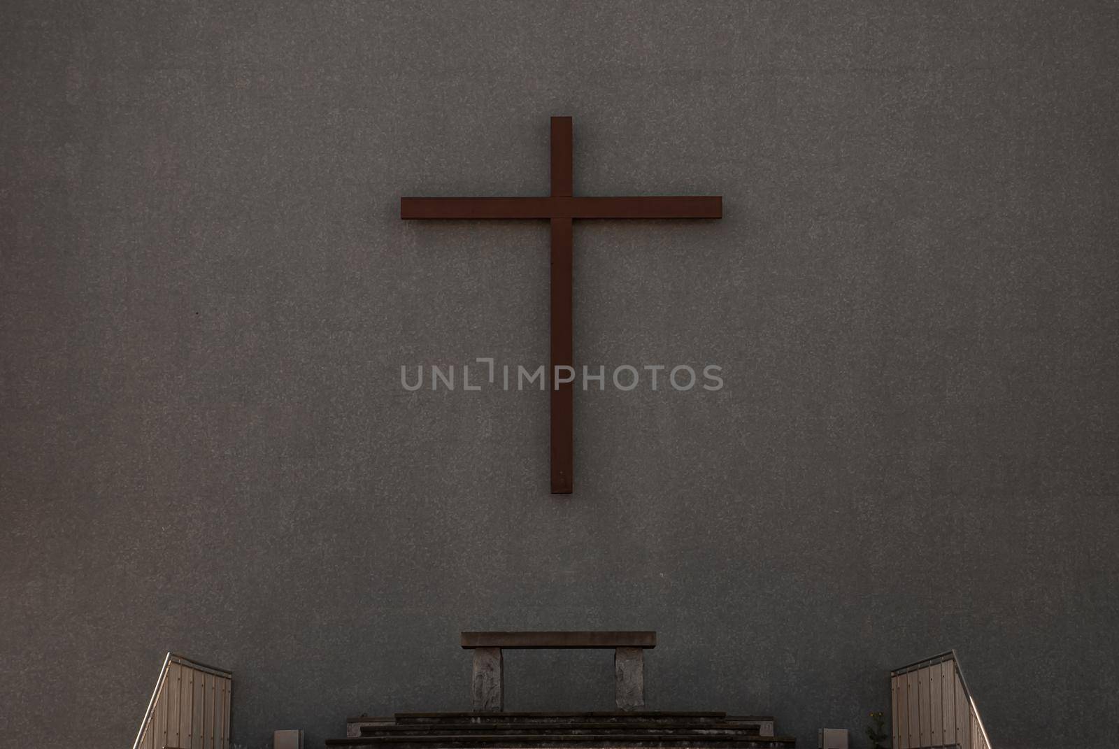 Christian wooden crucifix on a wall background The back of the christ church. copy space, selective focus.