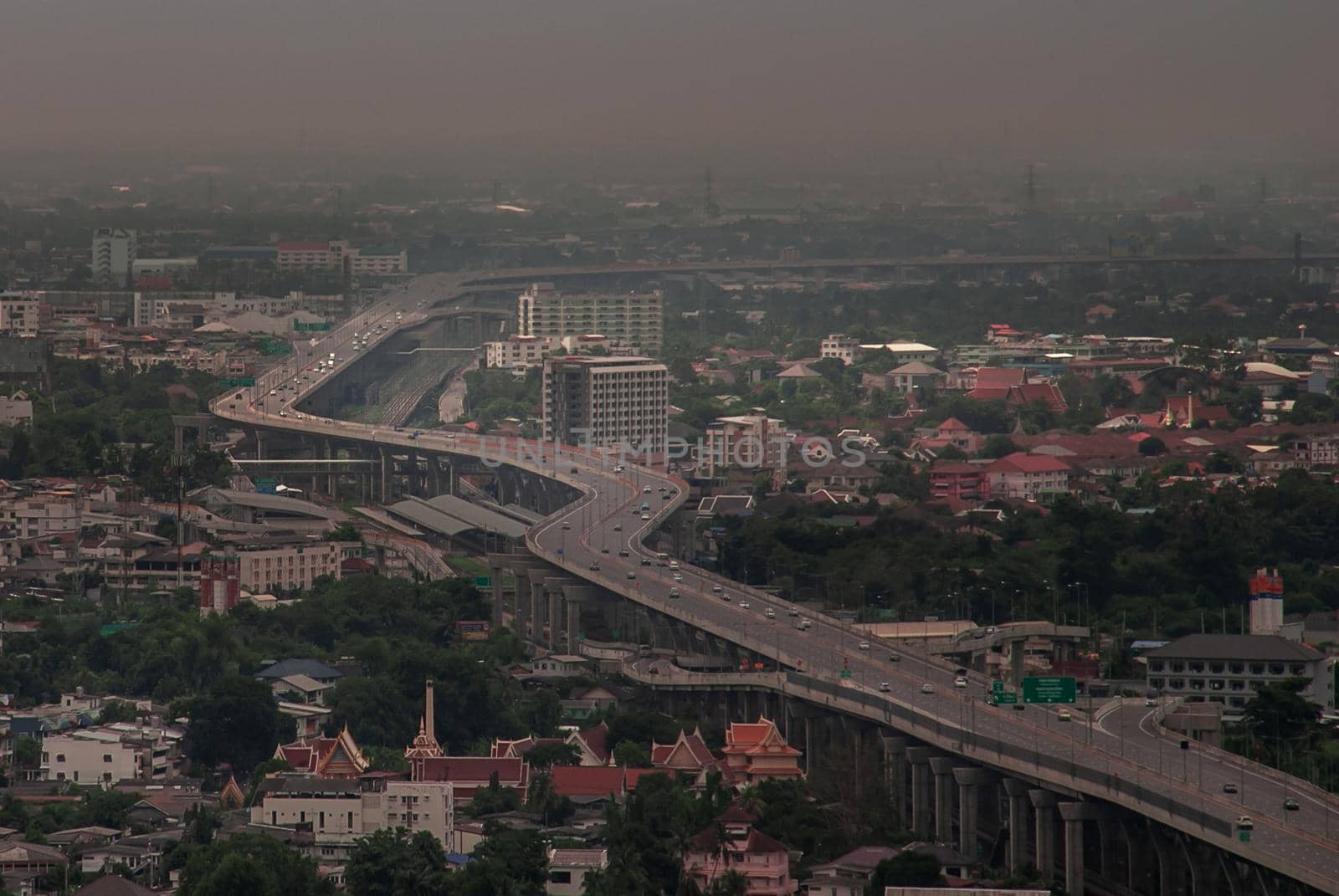 Bangkok, Thailand - Oct 05, 2019 : Aerial view of cars driving on highway junctions. Bridge roads with green garden and trees in connection of architecture concept. Top view. Urban city.