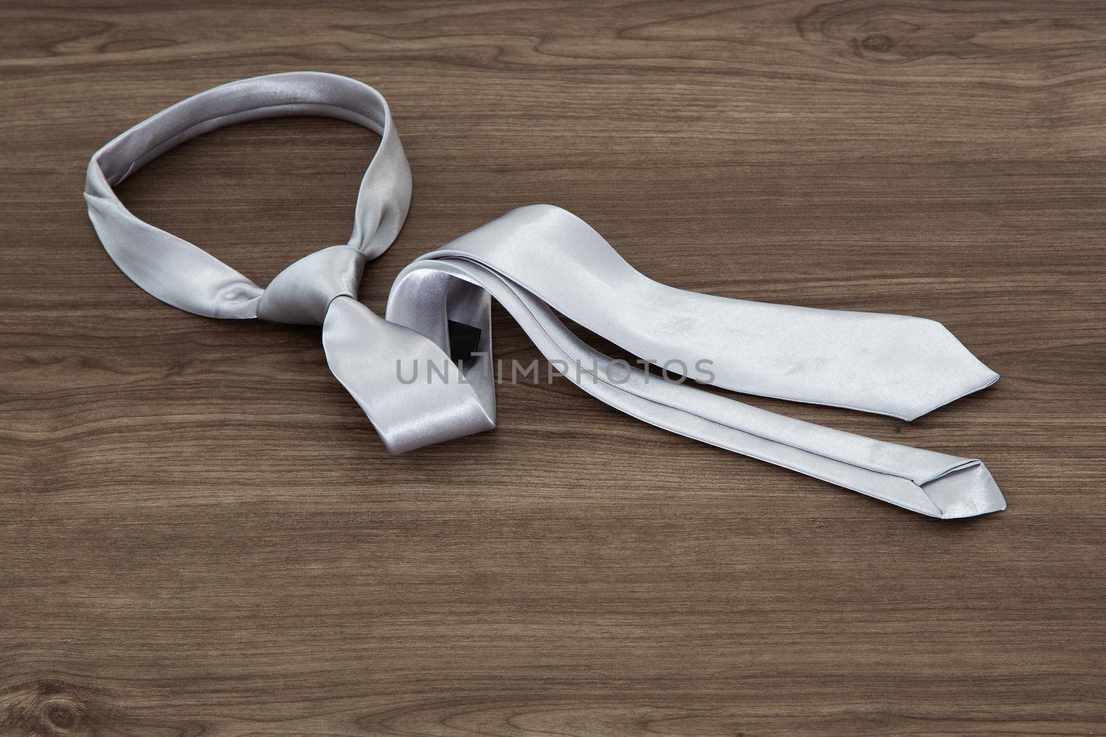 Silver color necktie on table by tehcheesiong