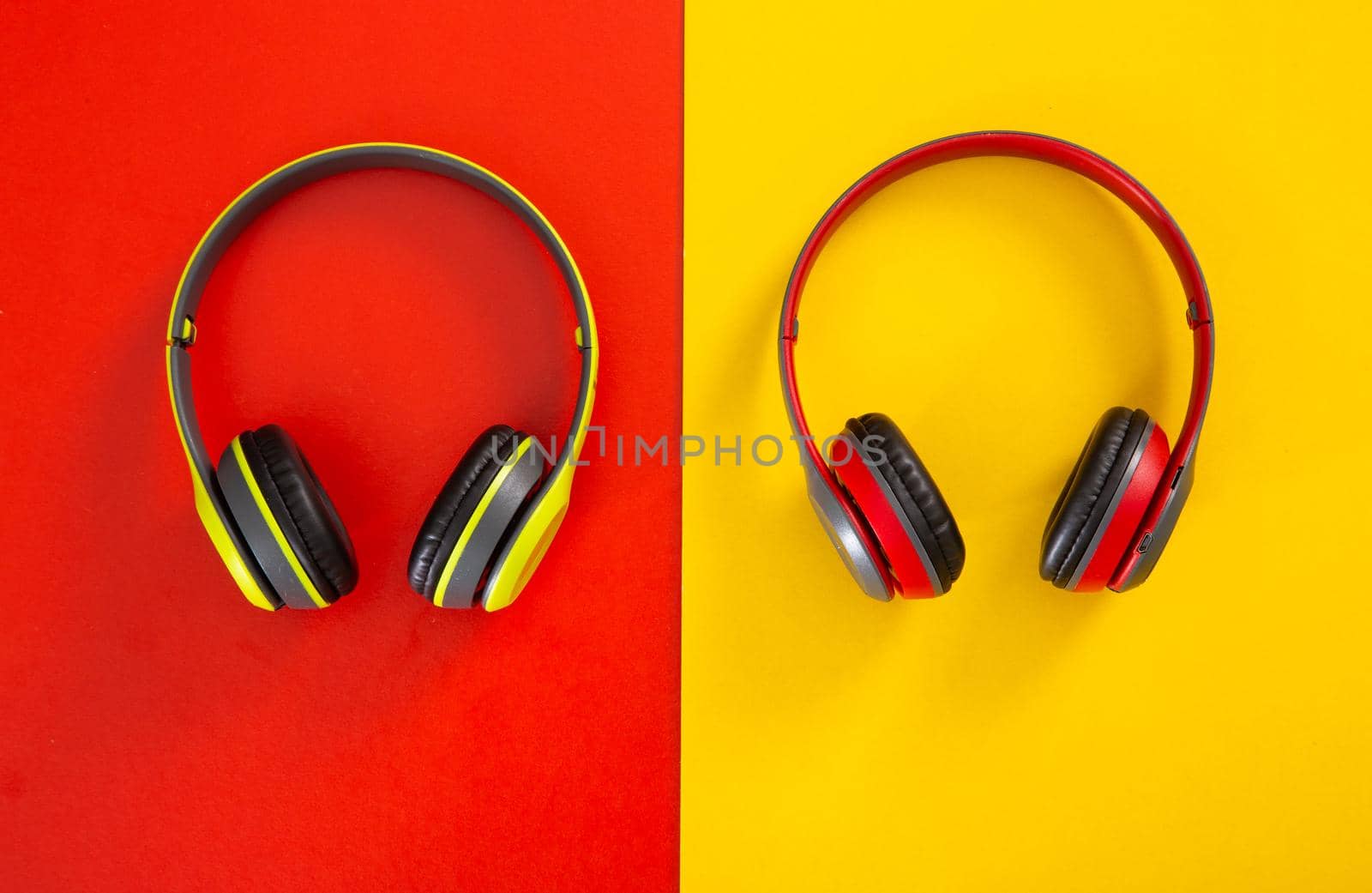 headphones on red and yellow  background. Music concept.