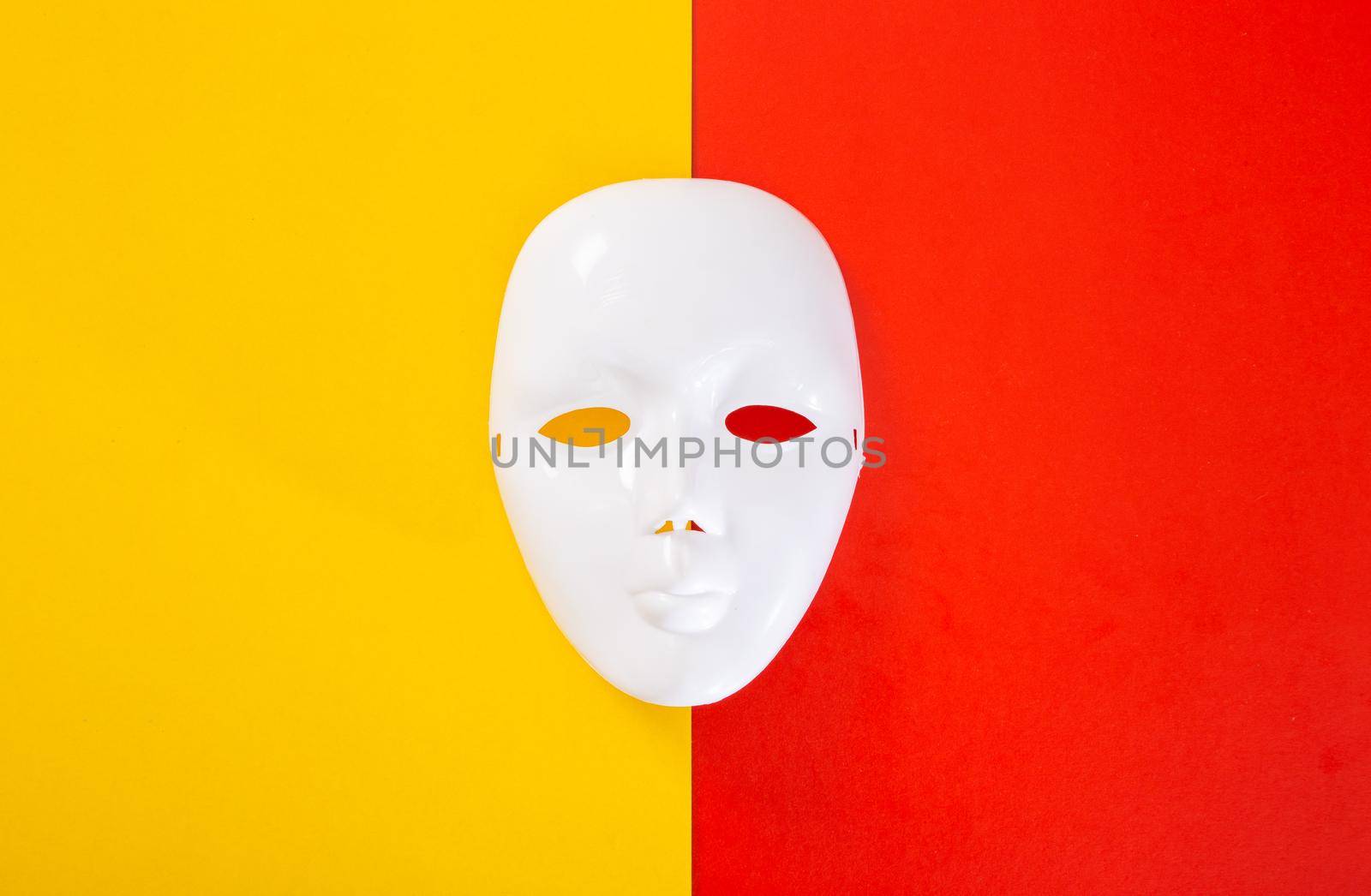 carnival white mask on red and yellow background