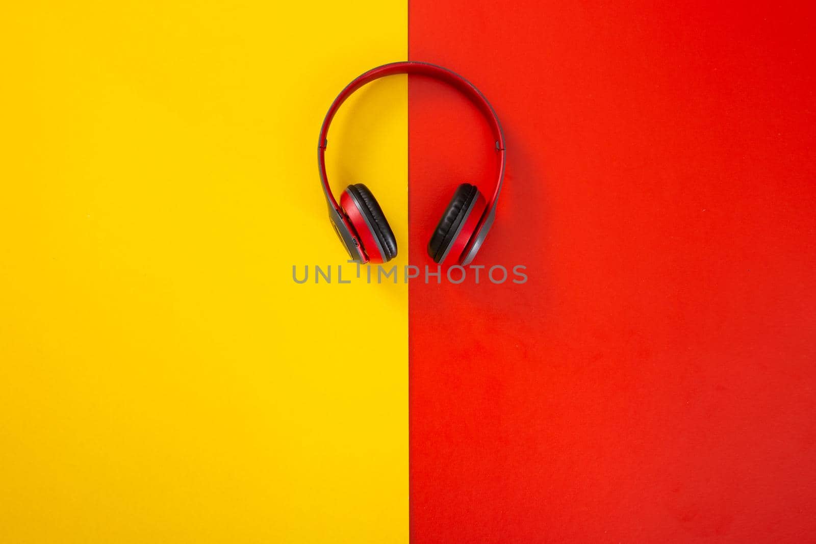 headphones on red and yellow  background. Music concept.