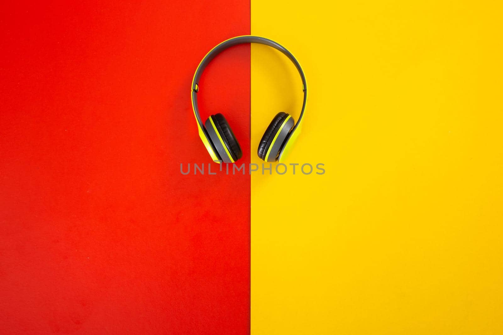 headphones on red and yellow  background. by tehcheesiong