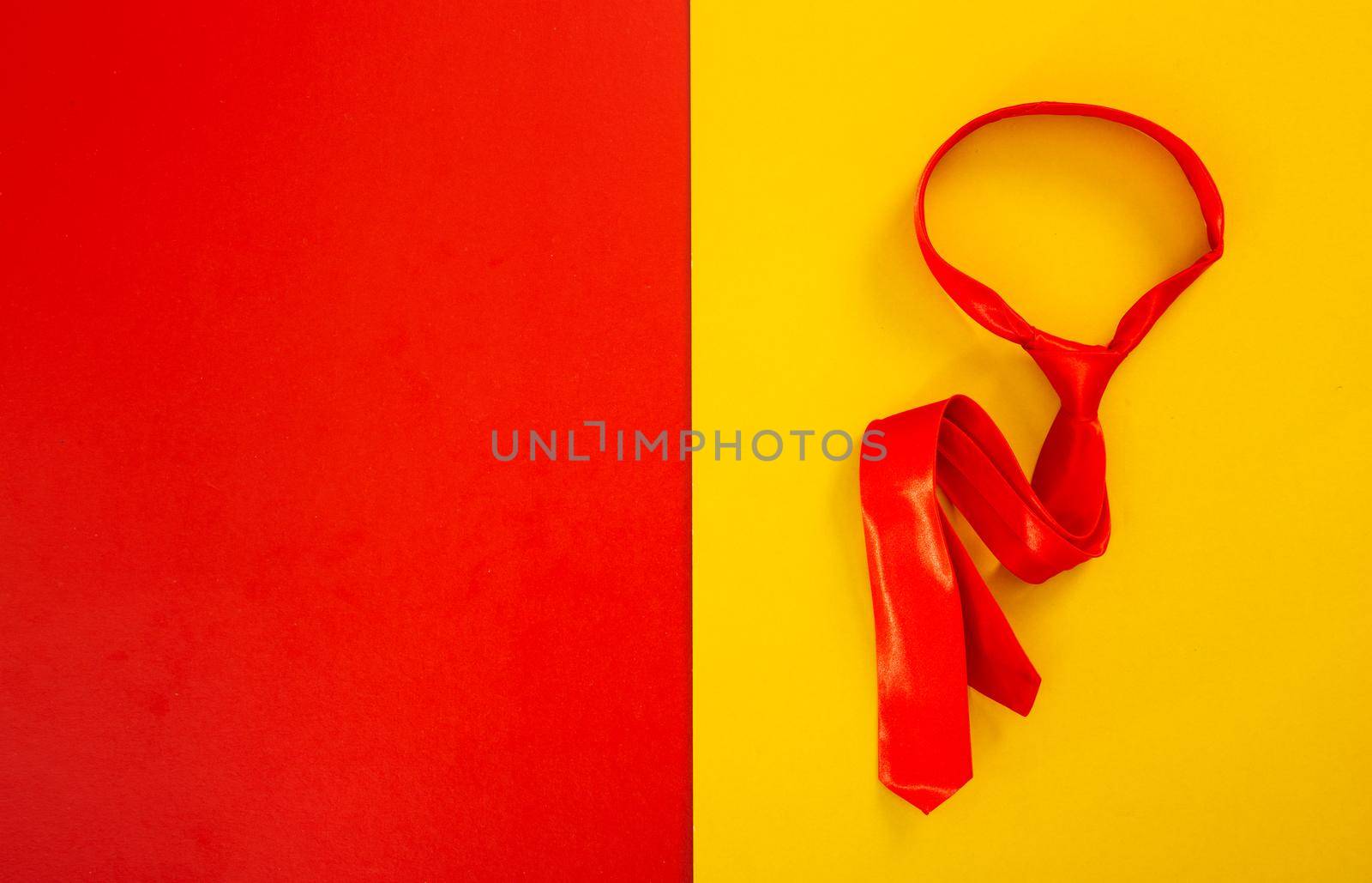 red necktie on red and yellow background