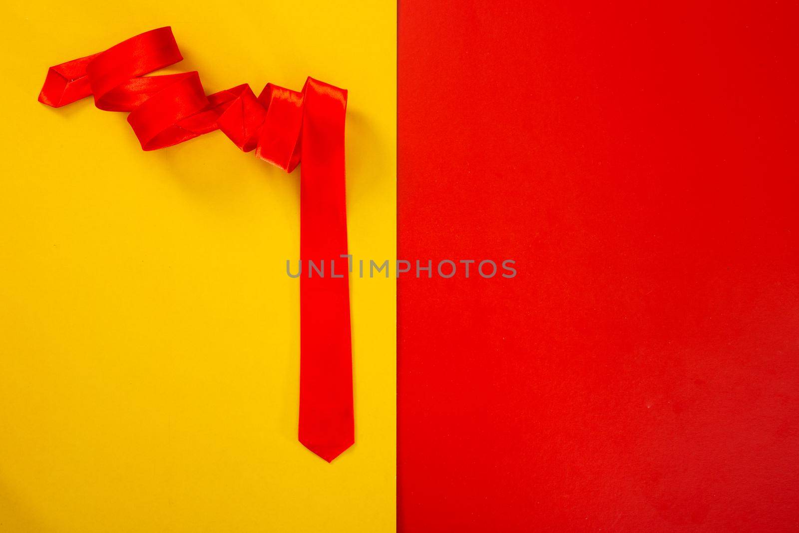 red necktie on red and yellow background