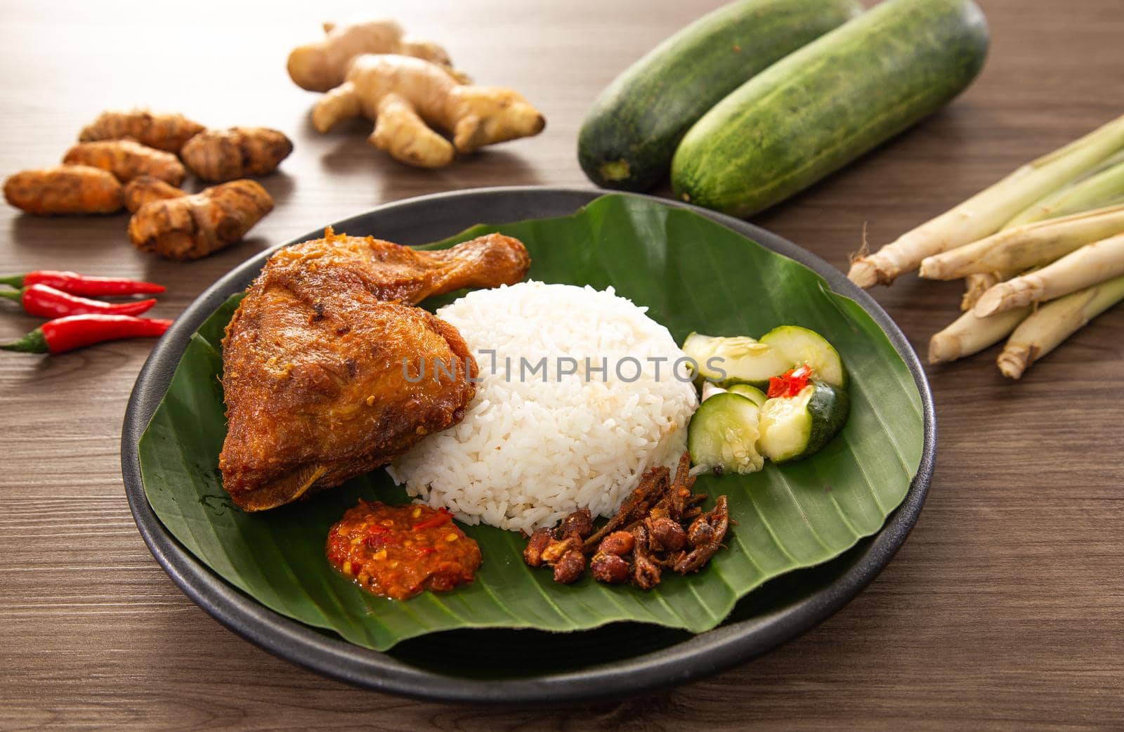 Nasi Kukus is usually comprising freshly steamed rice, crispy fried chicken, sambal belacan, acar and a curry gravy