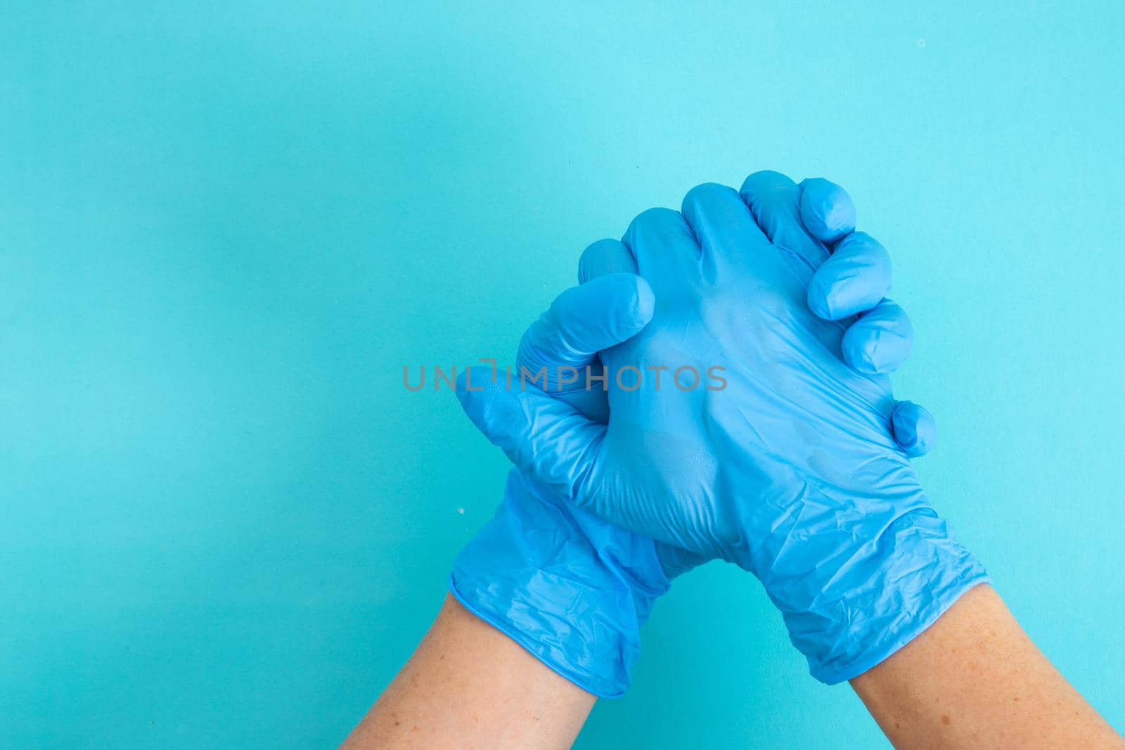 hands wearing blue glove, holding hands to supporting.
