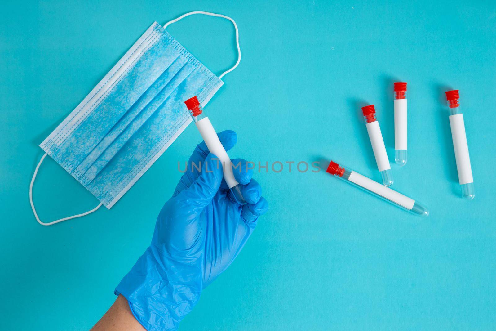 top view of doctor holding sample in test tube. by tehcheesiong