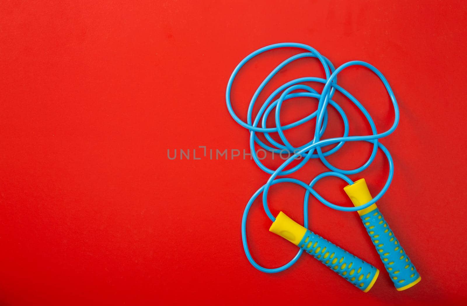 Minimalism fitness concept. Skipping rope on color background. Top view