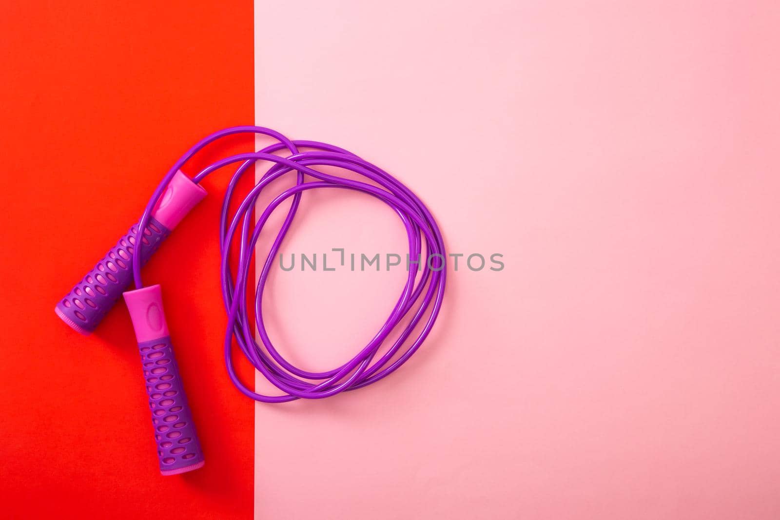 Minimalism fitness concept. Skipping rope on color background. by tehcheesiong