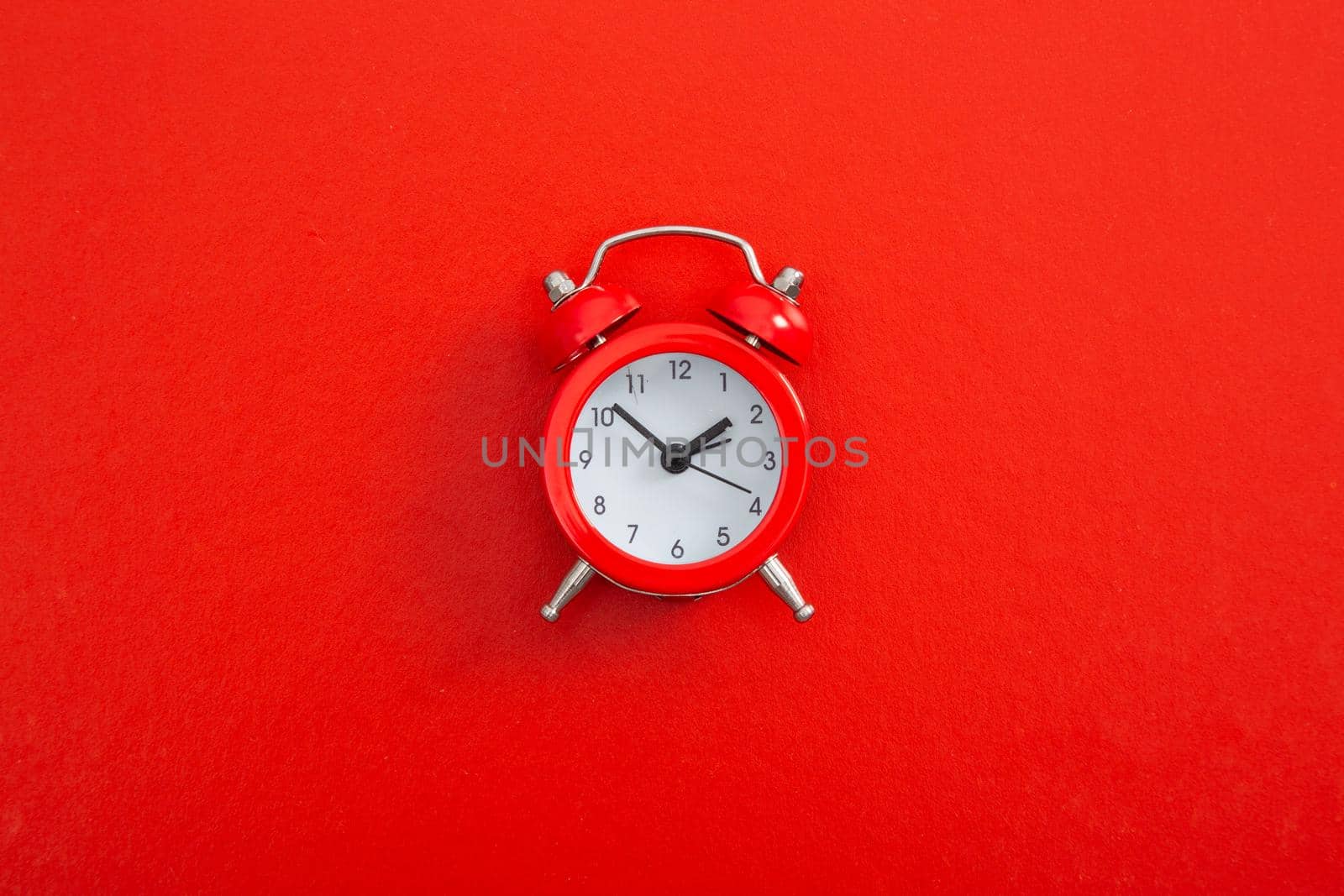 Alarm clock on a color background. by tehcheesiong