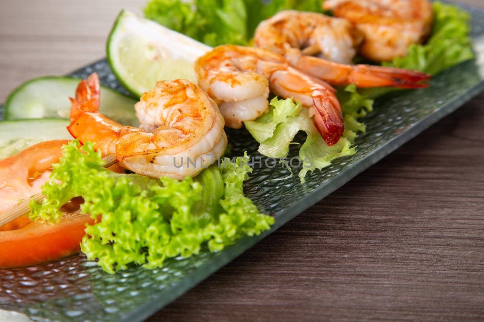 Skewers Barbeque grilled prawns on wooden table by tehcheesiong