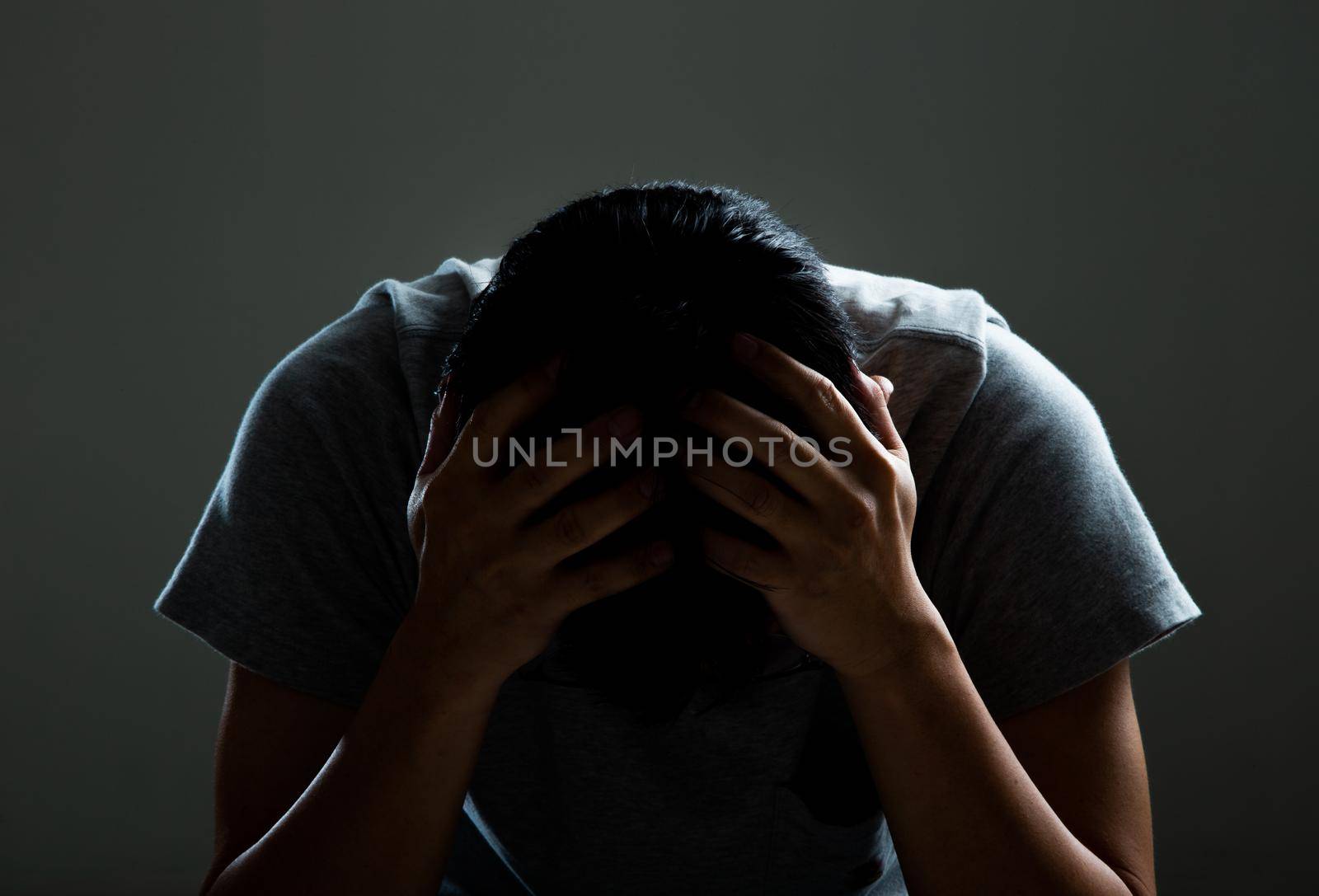 Sad and depressed man covering face - Feeling depressed background concept