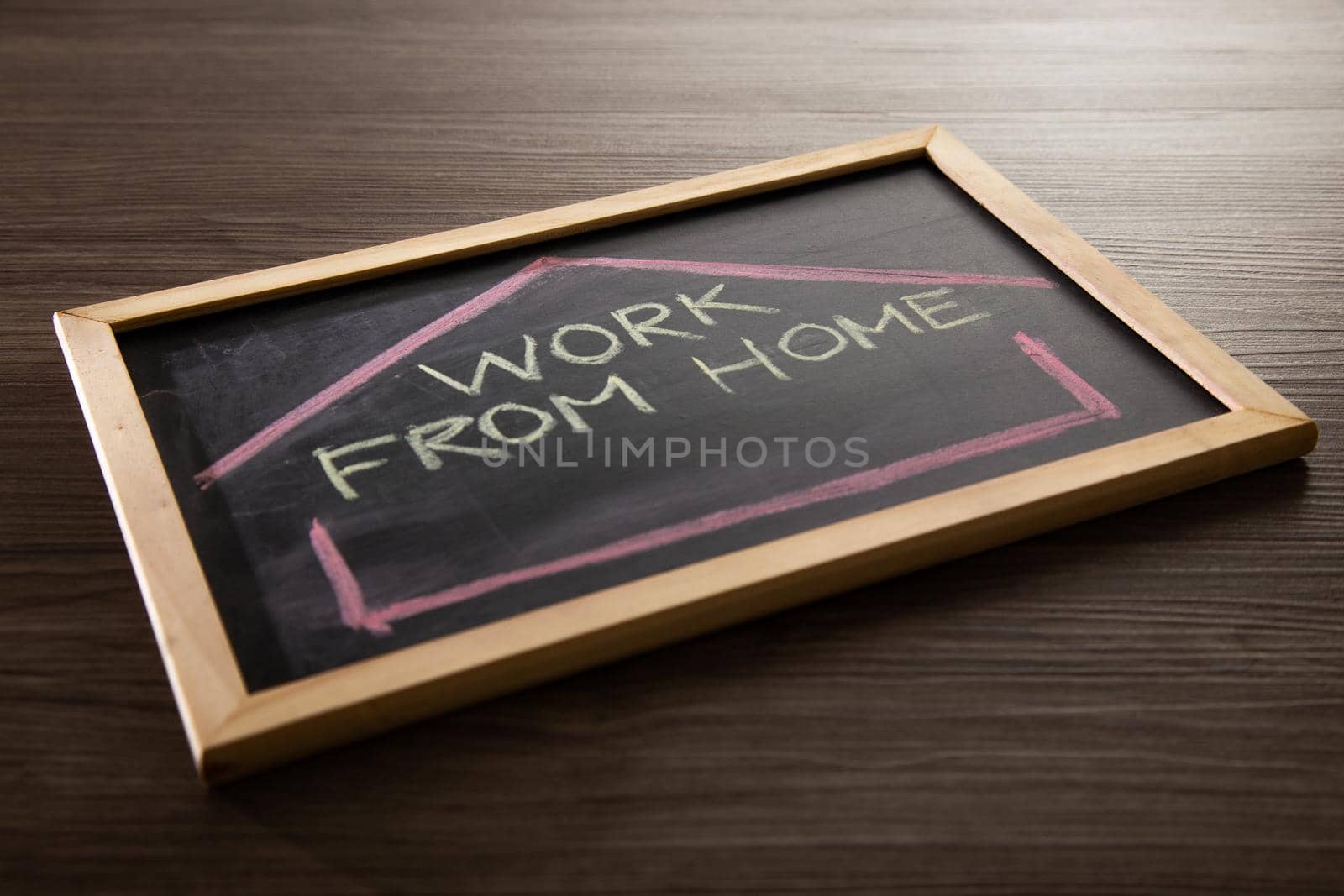 Work From Home word on blackboard written in chalk, Coronavirus concept.