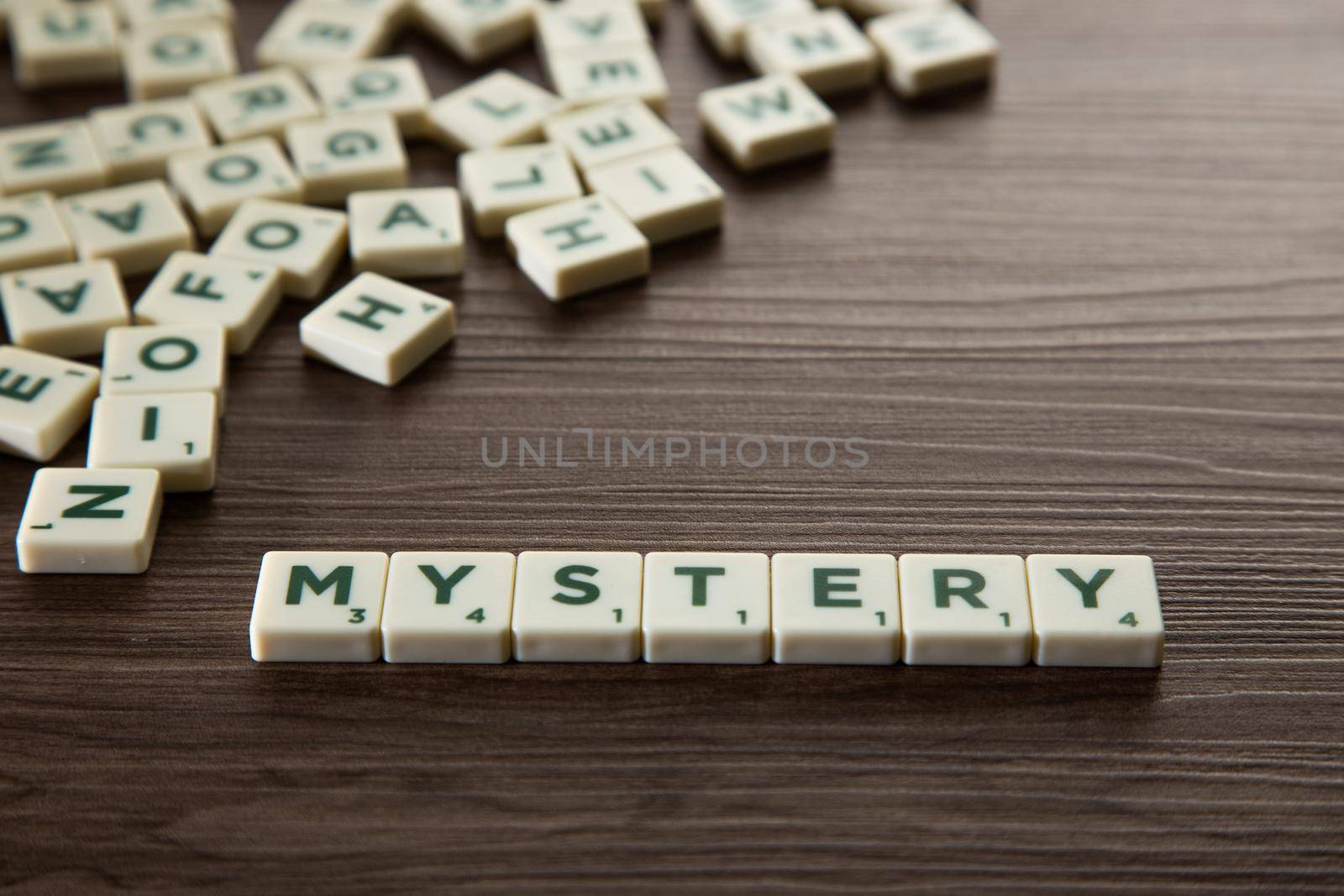 Alphabet block with Mystery word wooden table. Mystery concept.