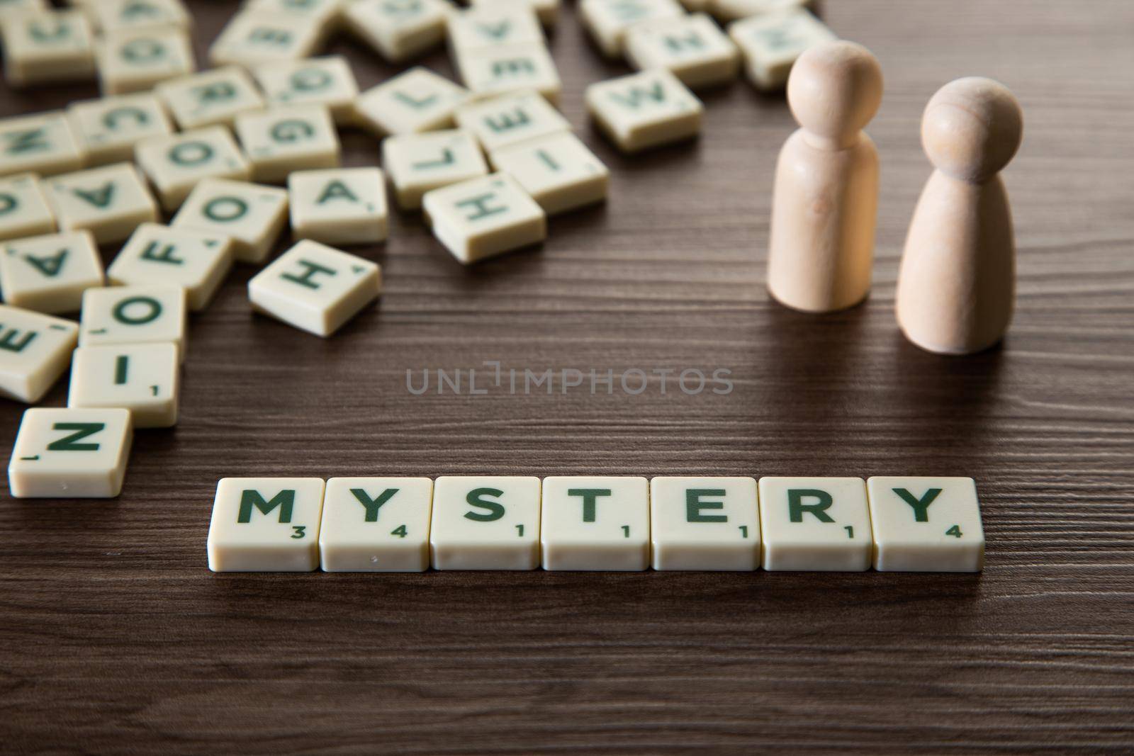 Alphabet block with Mystery word wooden table. Mystery concept.