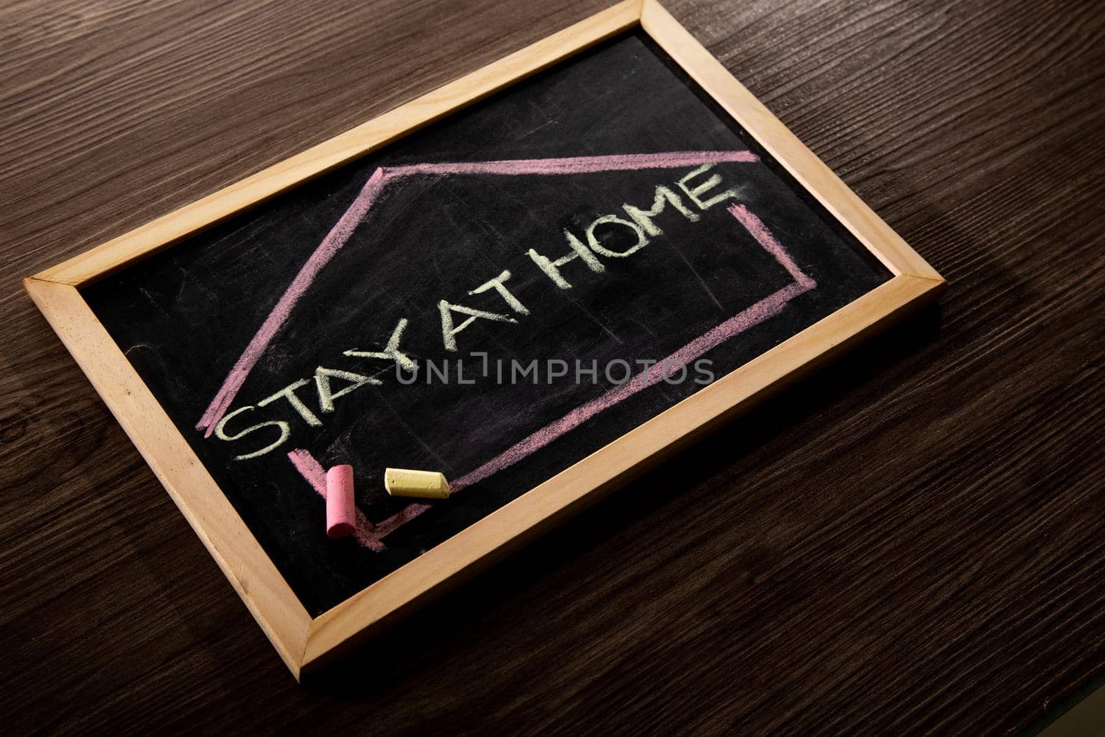 Stay at Home word on blackboard written in chalk, Coronavirus concept.