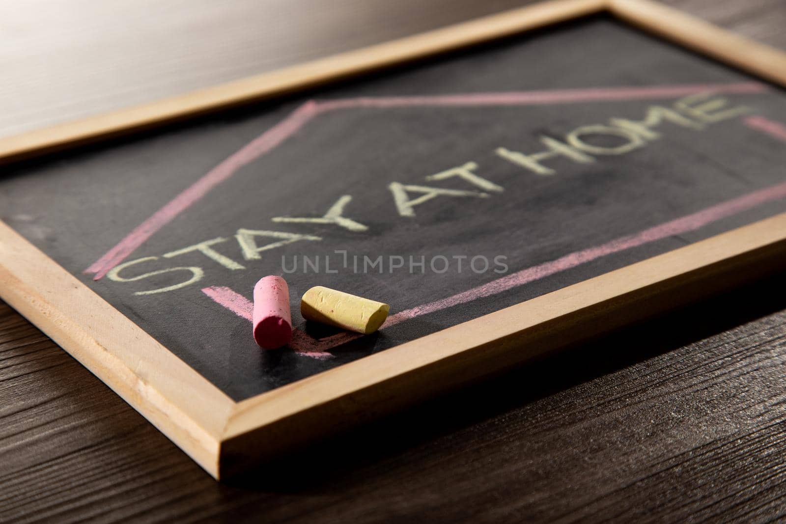 Stay at Home word on blackboard written in chalk, Coronavirus concept.