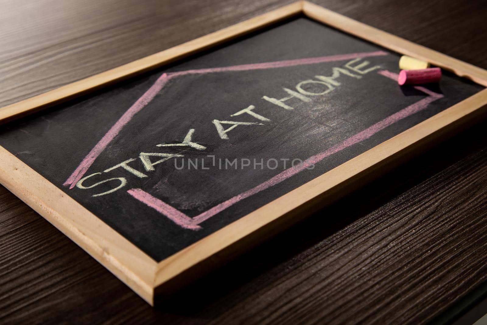 Stay at Home word on blackboard written in chalk, Coronavirus concept.