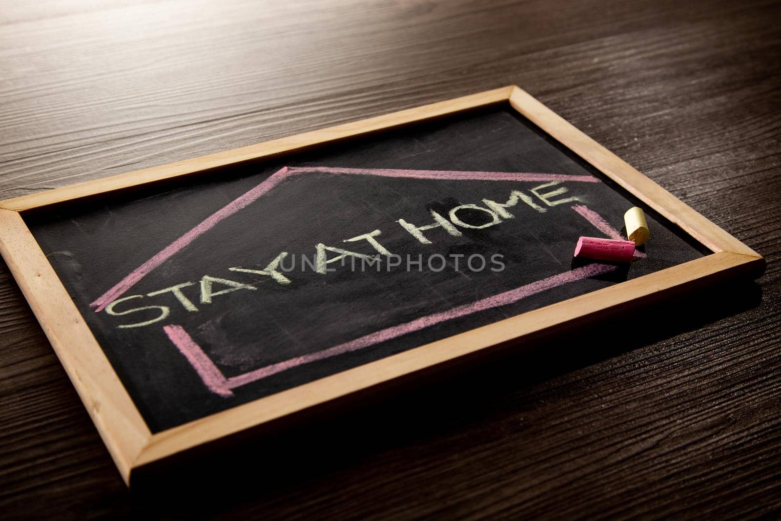 Stay at Home word on blackboard written in chalk, Coronavirus concept.
