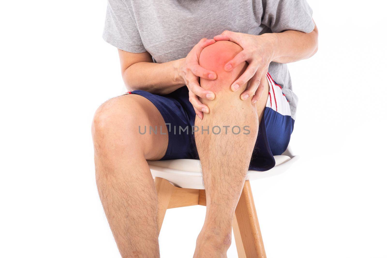 Sore pain of knee. Sprain and arthritis symptoms. middle age man holding his hurt knee over white background.
