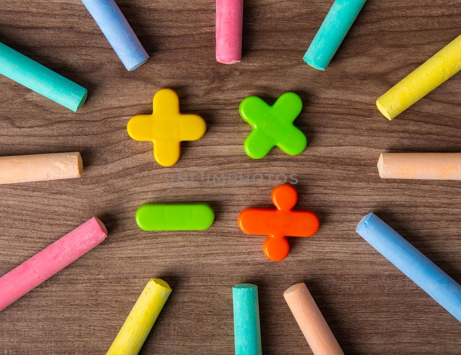 Mathematical math symbols with color chalks on wooden background
