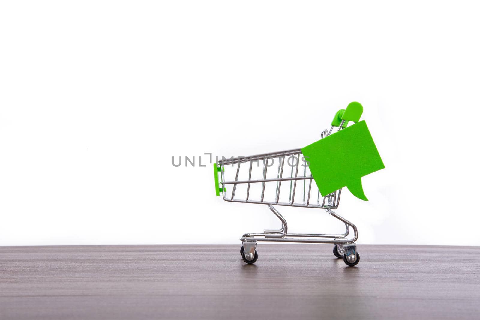 close-up of shopping trolley on white background with some copy space