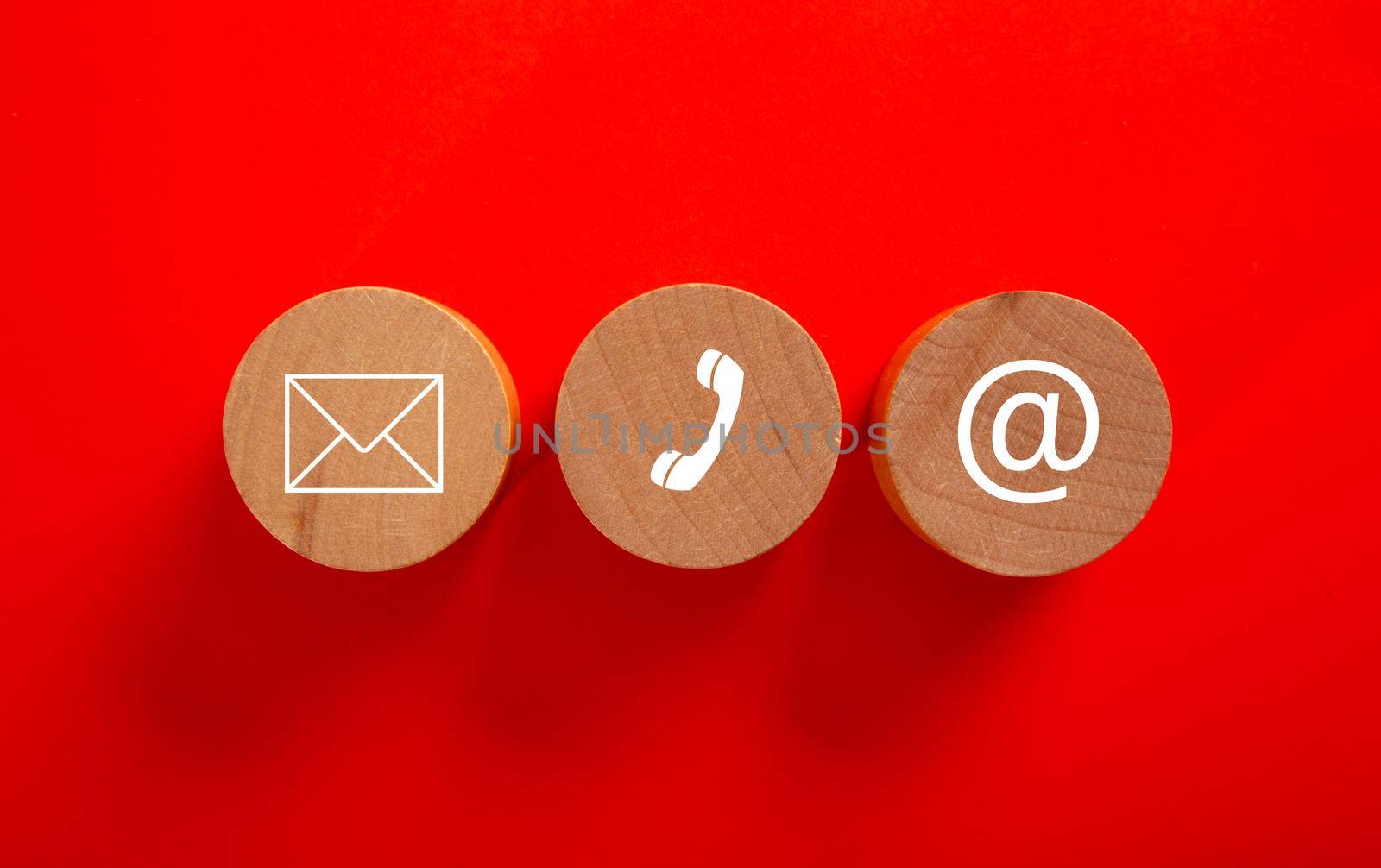 Wooden block with symbol telephone, email and address. Conceptual of contact us and e-mail marketing concept.