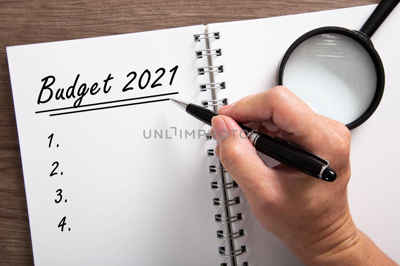 Hand writting BUDGET 2021 . Planning notes writing concepts. 2021 budget notepad