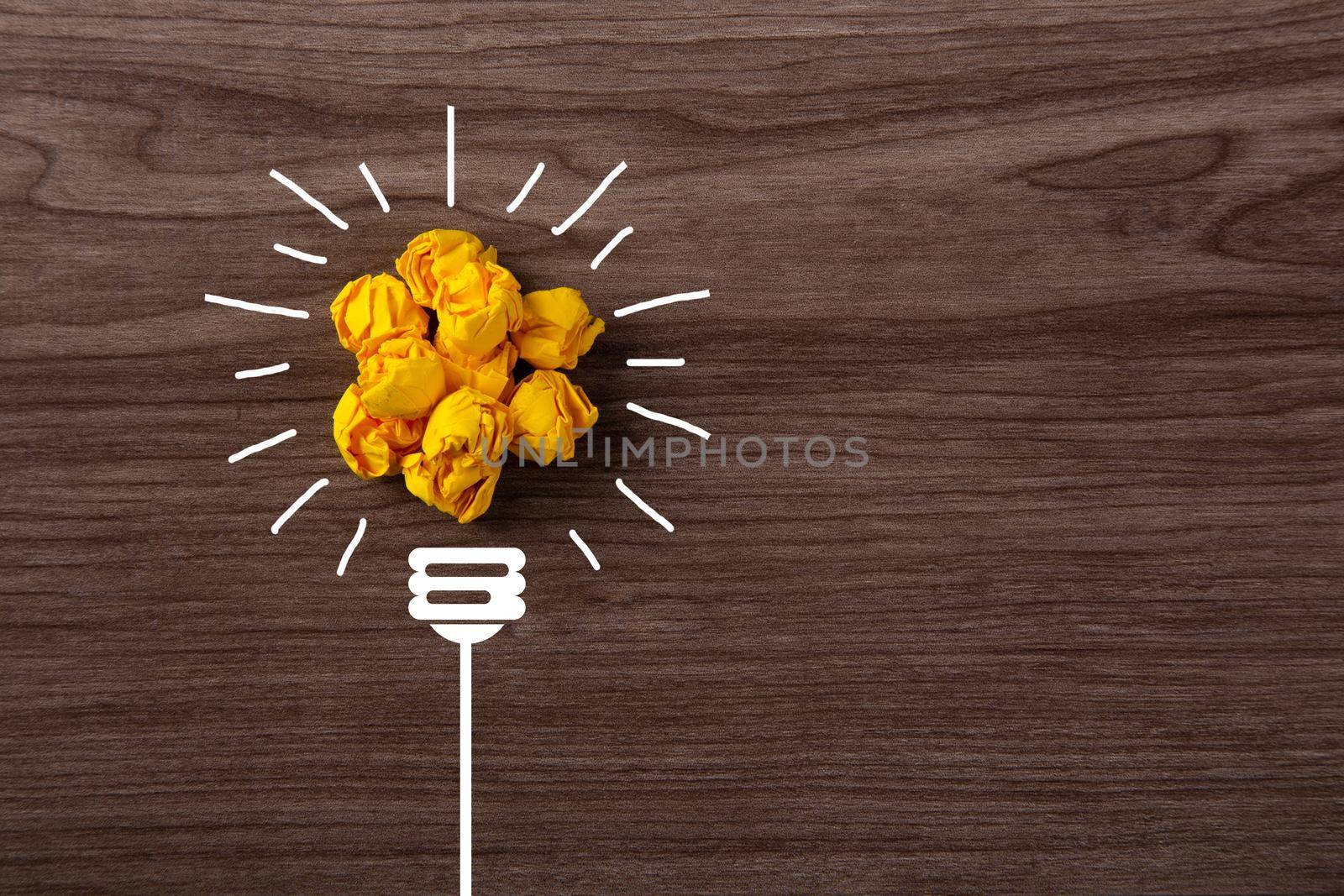 Creative idea, Inspiration, New idea and Innovation concept with Crumpled Paper light bulb on wooden background