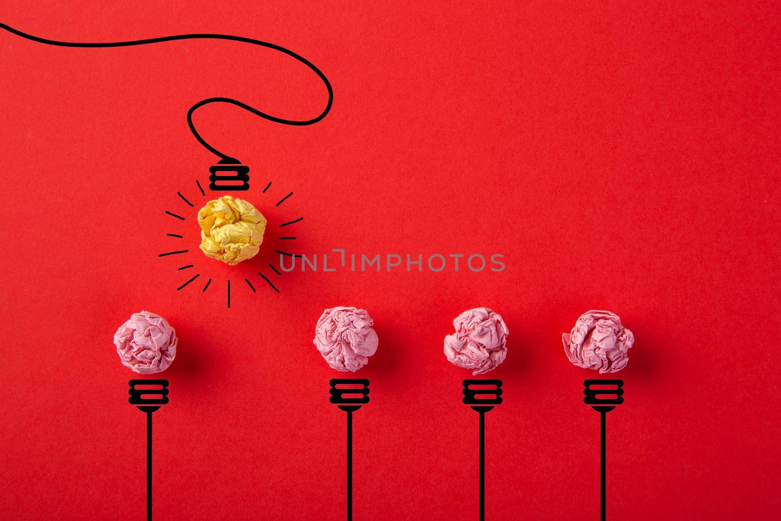 Inspiration concept crumpled paper light bulb metaphor for good idea on red background
