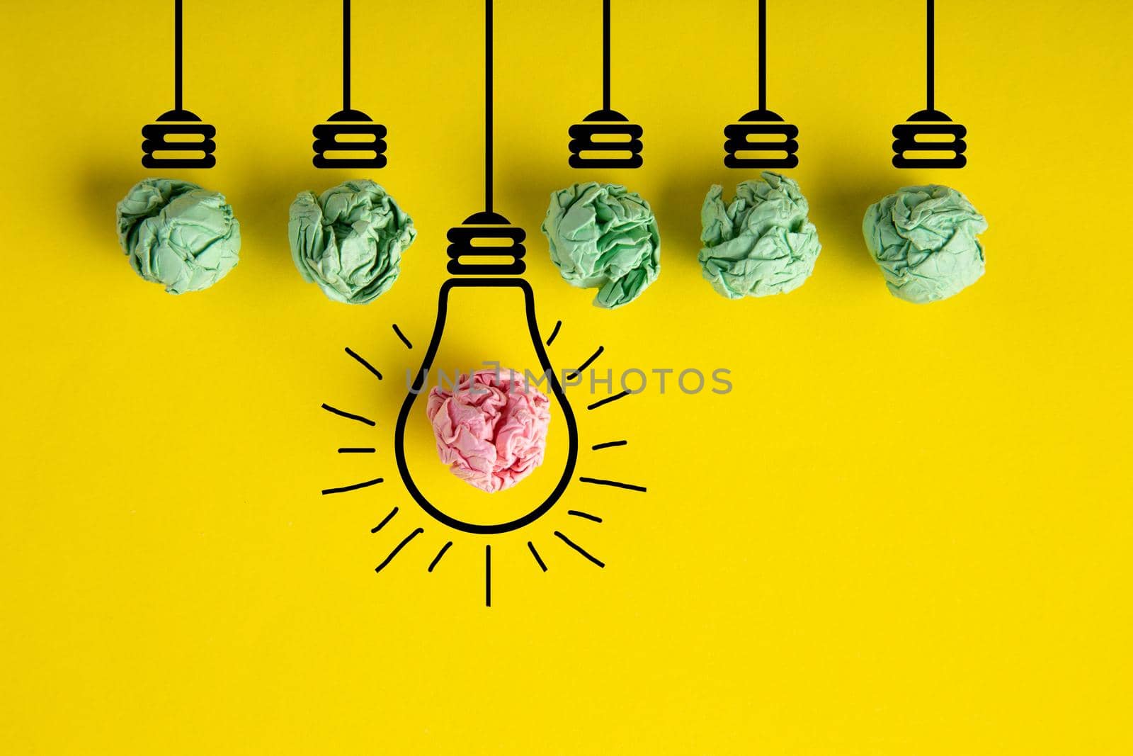 Inspiration concept crumpled paper light bulb metaphor for good idea on yellow background