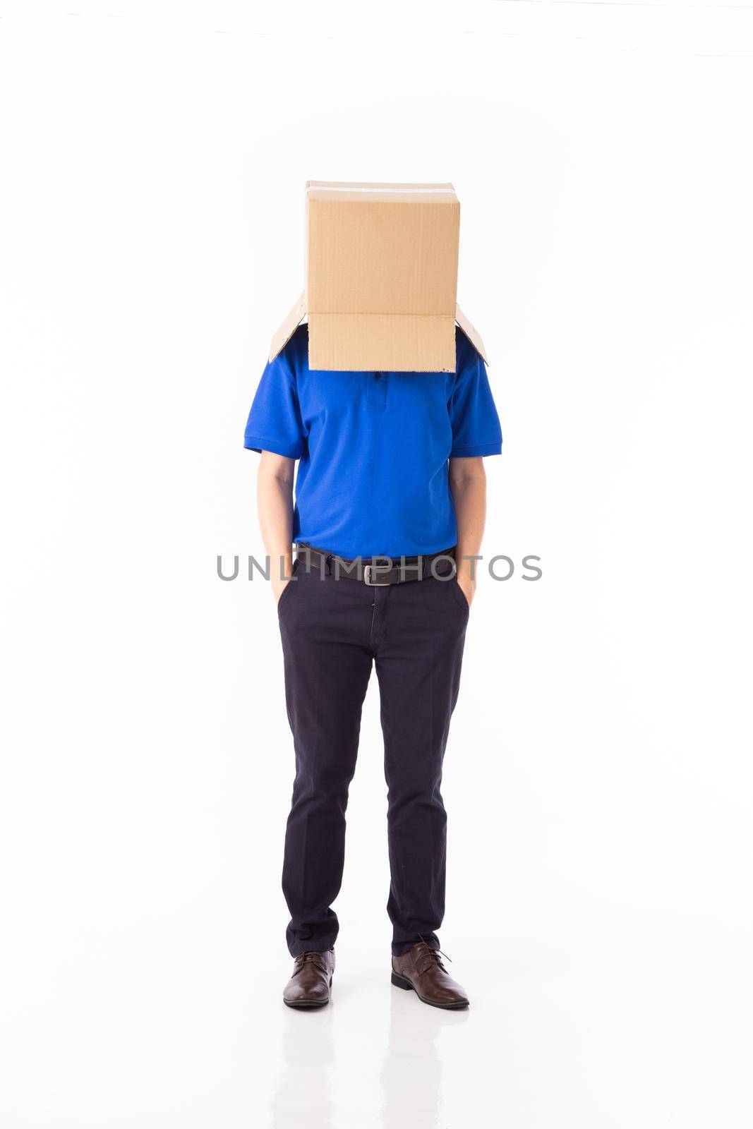 man in a bluer T-shirt with a cardboard box on his head makes a gesture with his hands isolated on white background