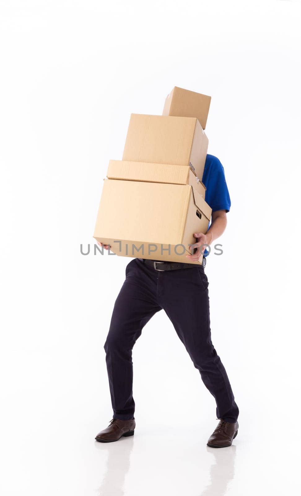 young Asian delivery man in blue uniform, carrry cardboard box in hands isolated on white background. Delivery concept