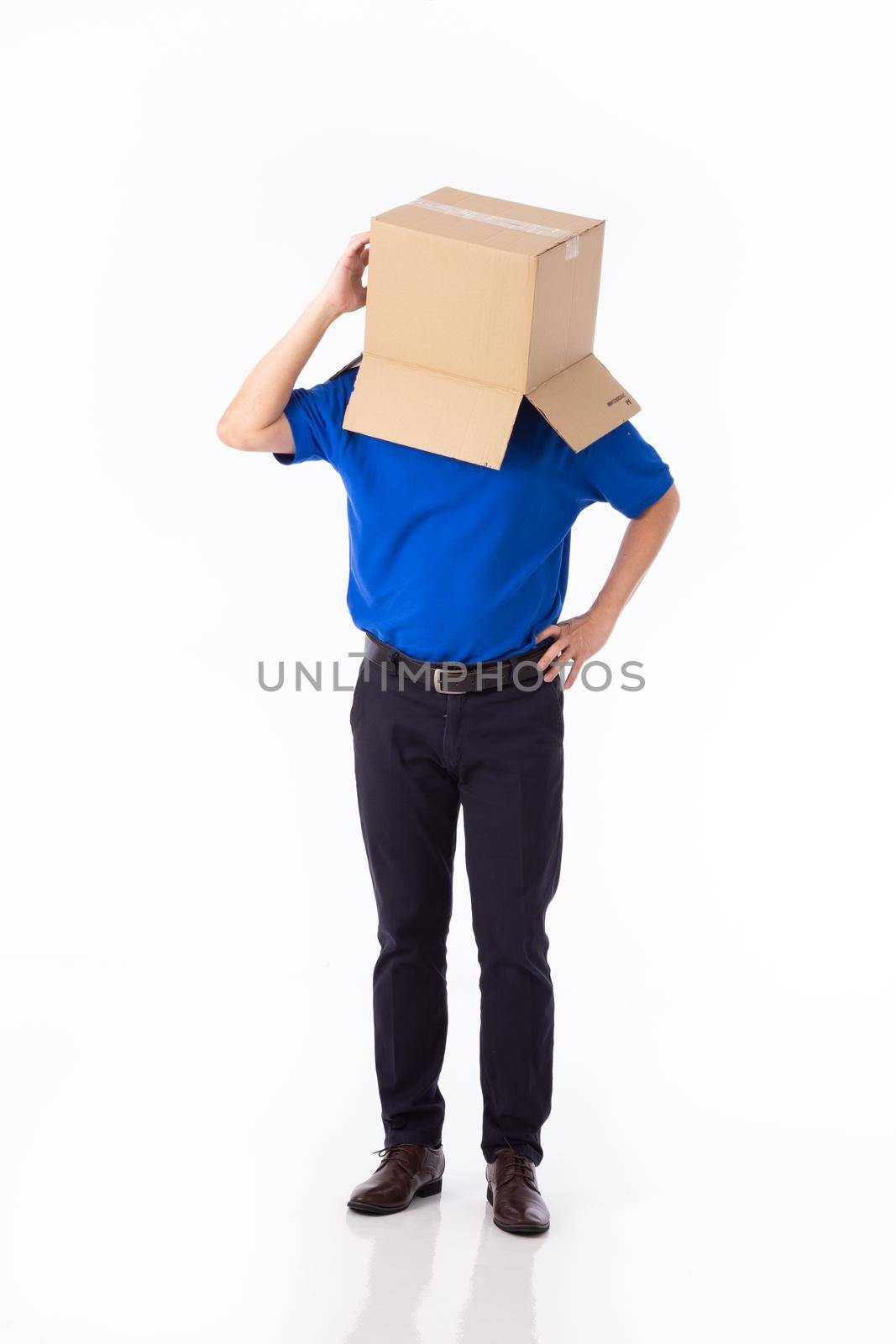 man in a bluer T-shirt with a cardboard box on his head makes a gesture with his hands isolated on white background