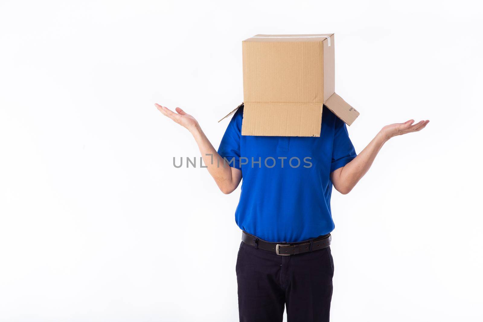 man in a bluer T-shirt with a cardboard box on his head makes a gesture with his hands isolated on white background