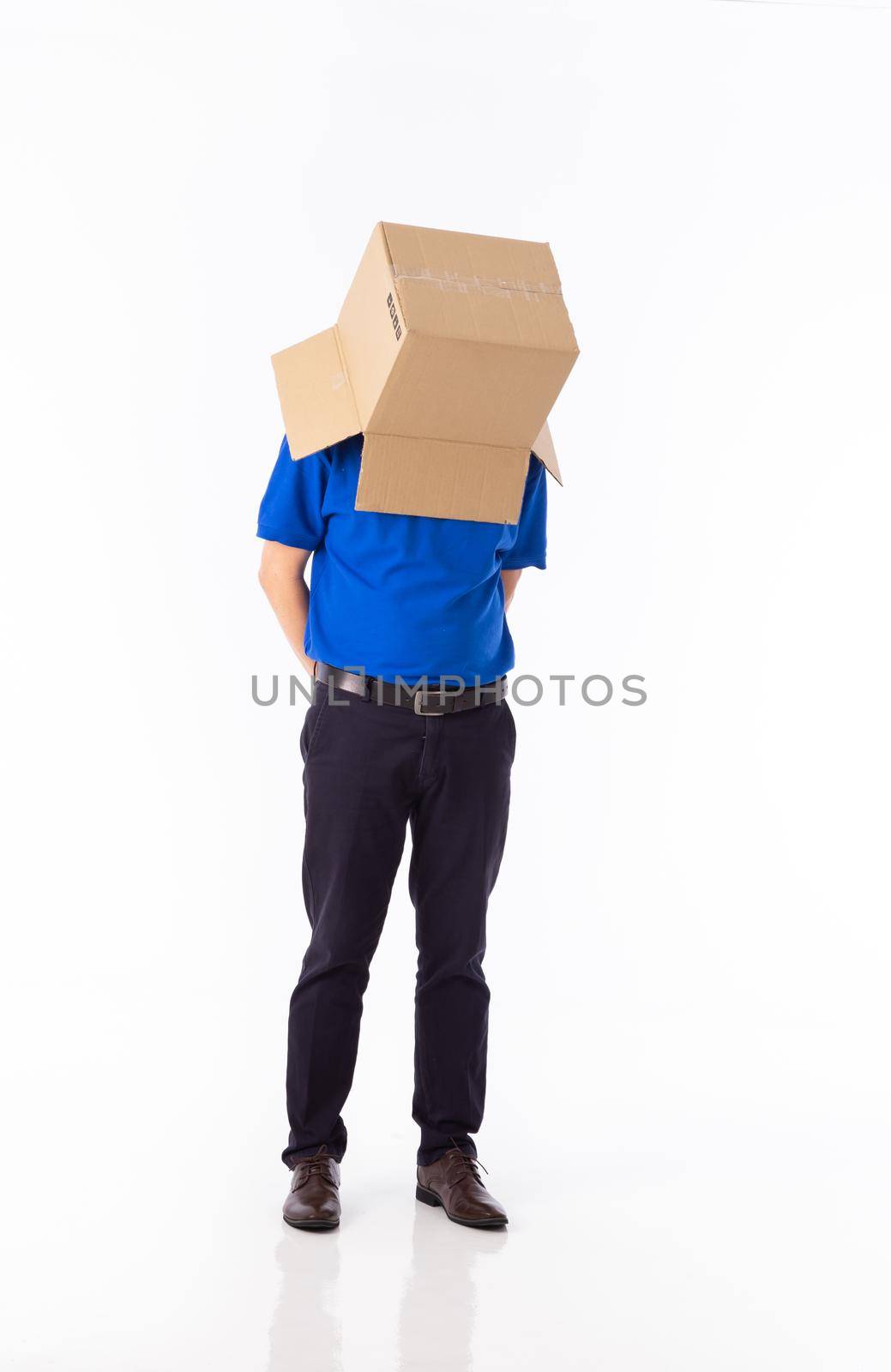 man in a bluer T-shirt with a cardboard box on his head makes a gesture with his hands isolated on white background