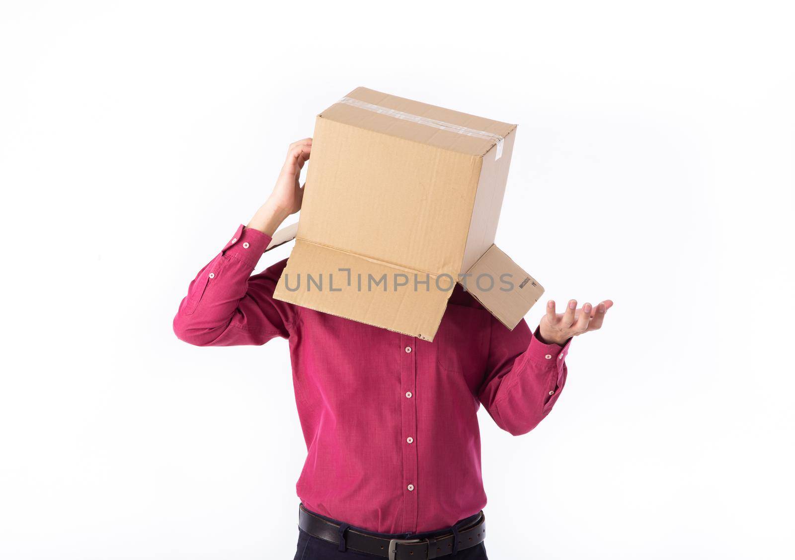 man in a red shirt with a cardboard box on his head makes a gesture with his hands isolated on white background