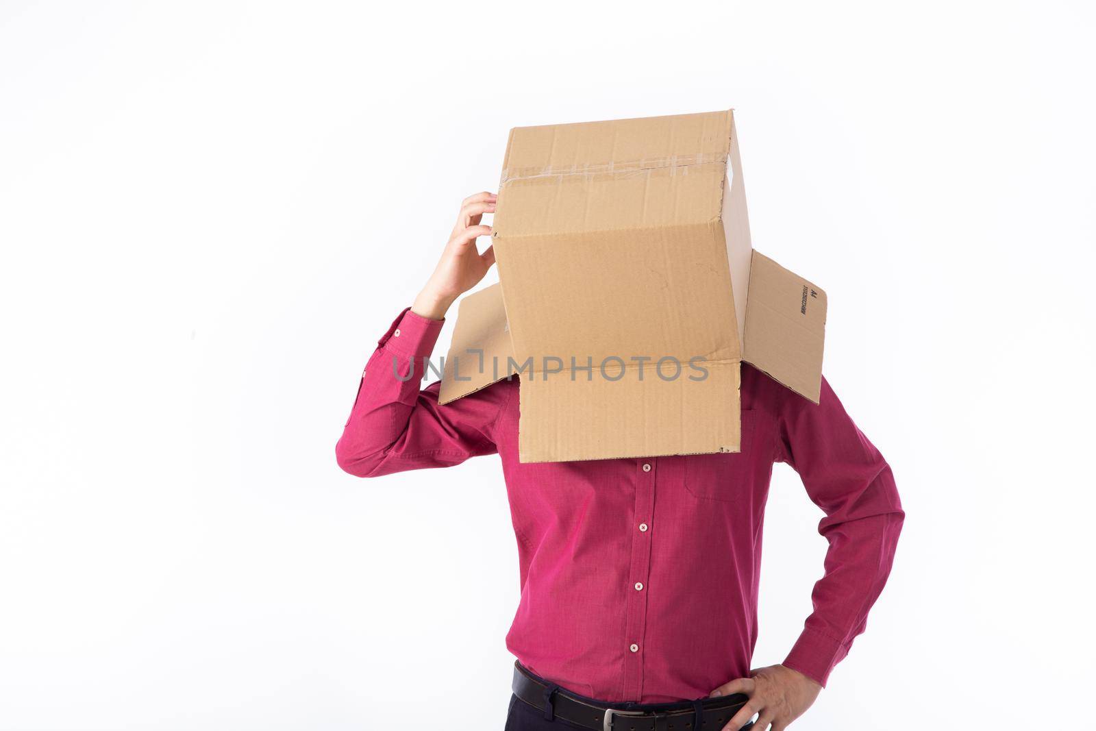 man in a red shirt with a cardboard box on his head makes a gesture with his hands by tehcheesiong